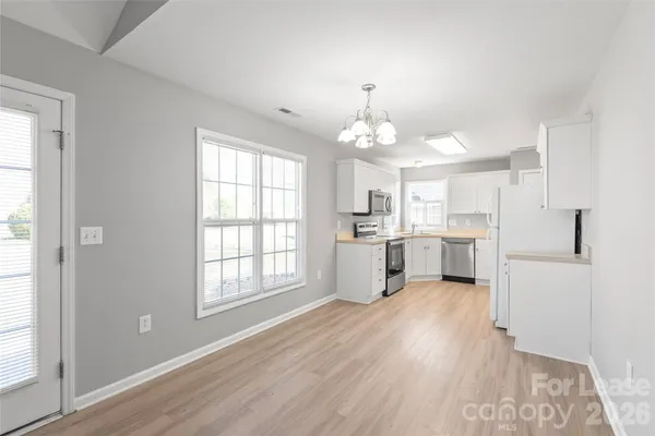 a view of a kitchen with sink and wooden floor
