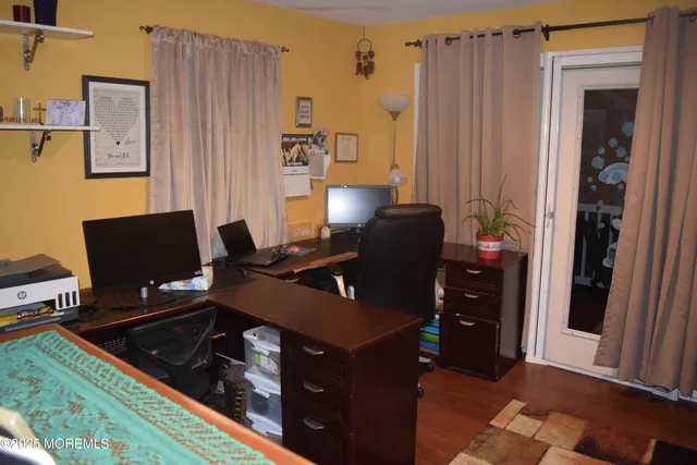 a view of hall way with furniture and floor to ceiling window