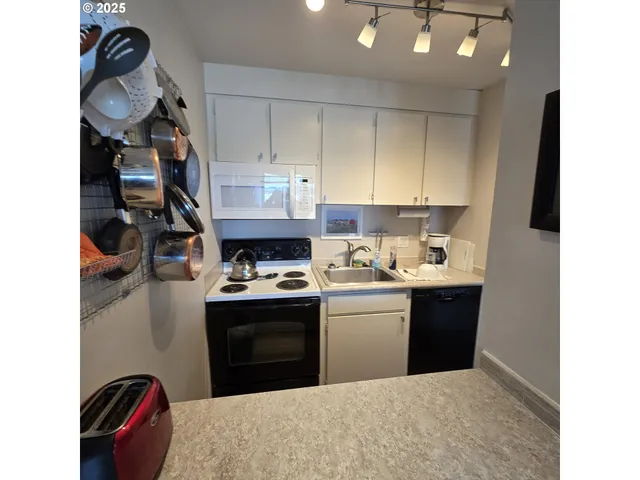 a kitchen with stainless steel appliances granite countertop a stove and a sink