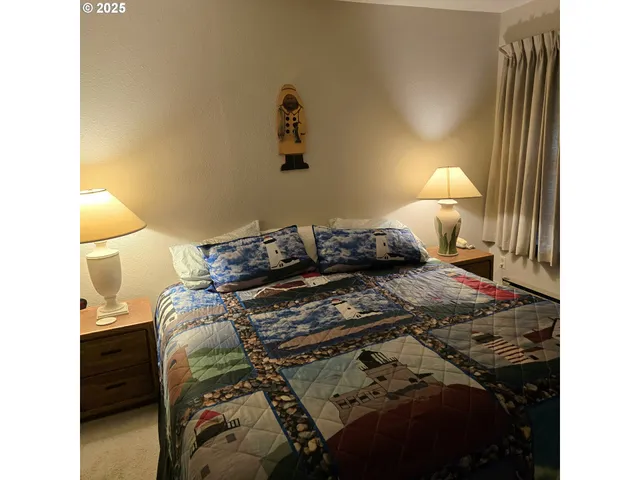 a bedroom with a bed and a lamp