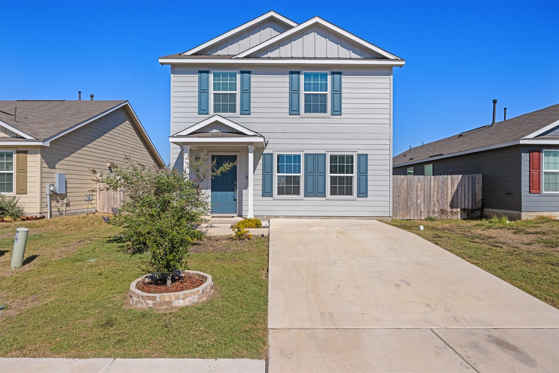 13520 Knights Branch Drive Elgin, TX 78621 - Photo 1 of 20 View of front of home with board and batten siding and concrete driveway