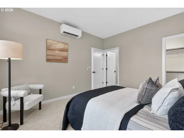 a bedroom with a bed and a lamp