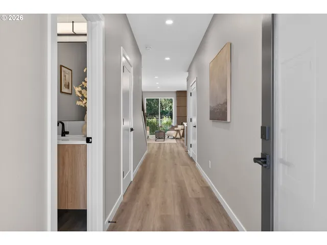 a view of hallway with wooden floor