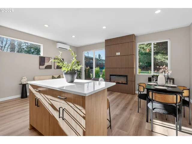 a kitchen with a stove a refrigerator and a dining table