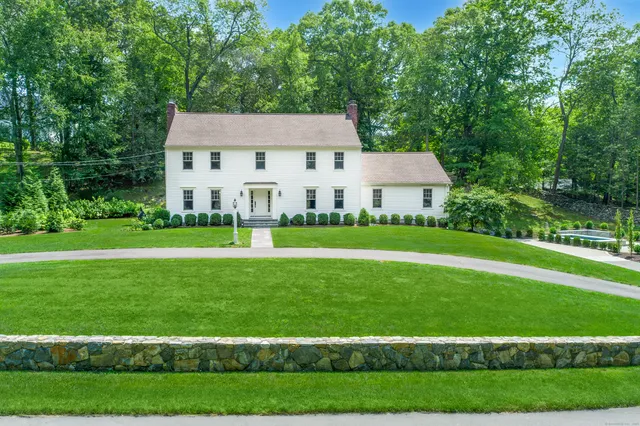 a view of house with a yard