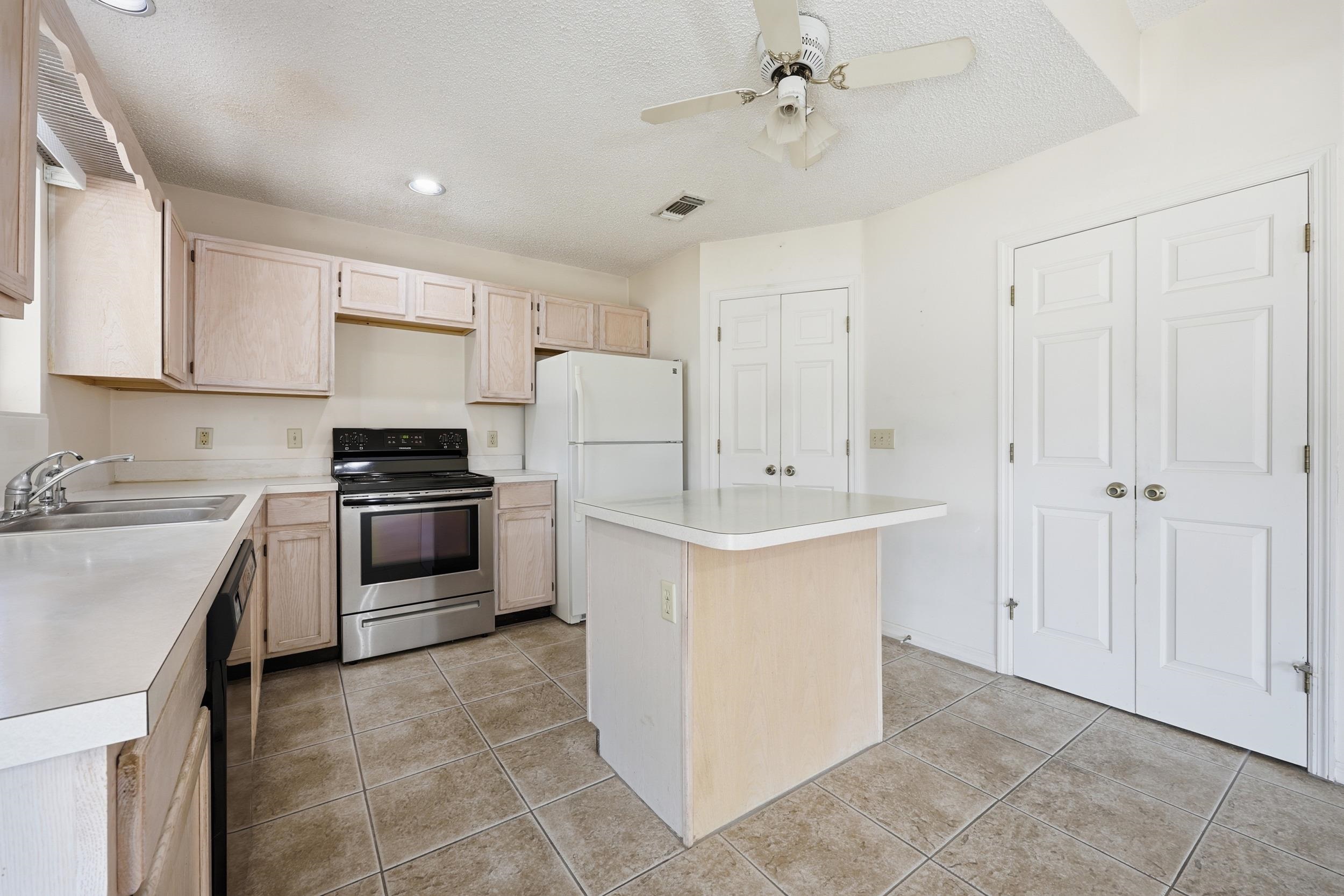 4628 Legends Lane Elkton, FL 32033 - Photo 12 of 49 a kitchen with a sink appliances and cabinets