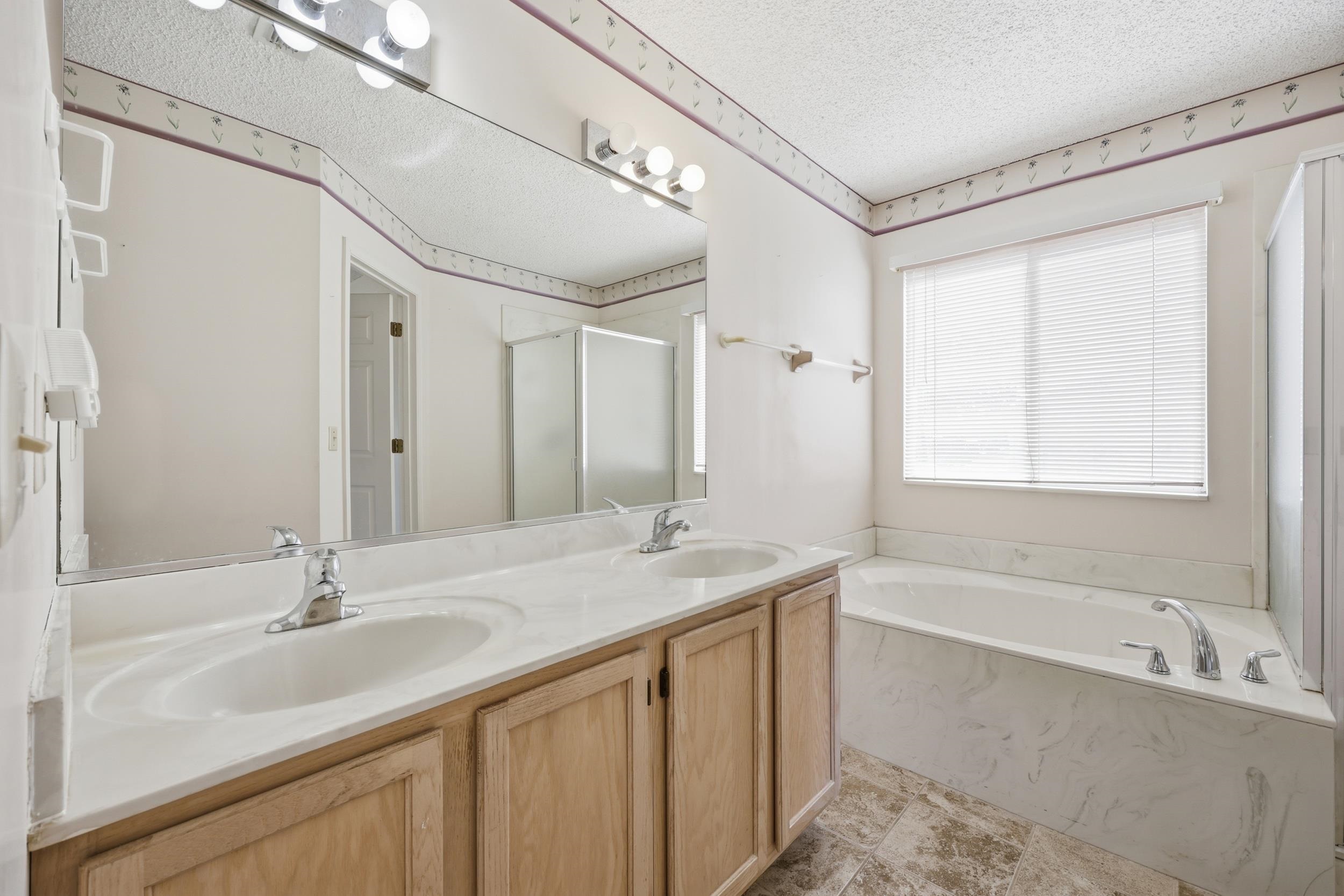 4628 Legends Lane Elkton, FL 32033 - Photo 20 of 49 a bathroom with a sink double vanity shower and a bathtub