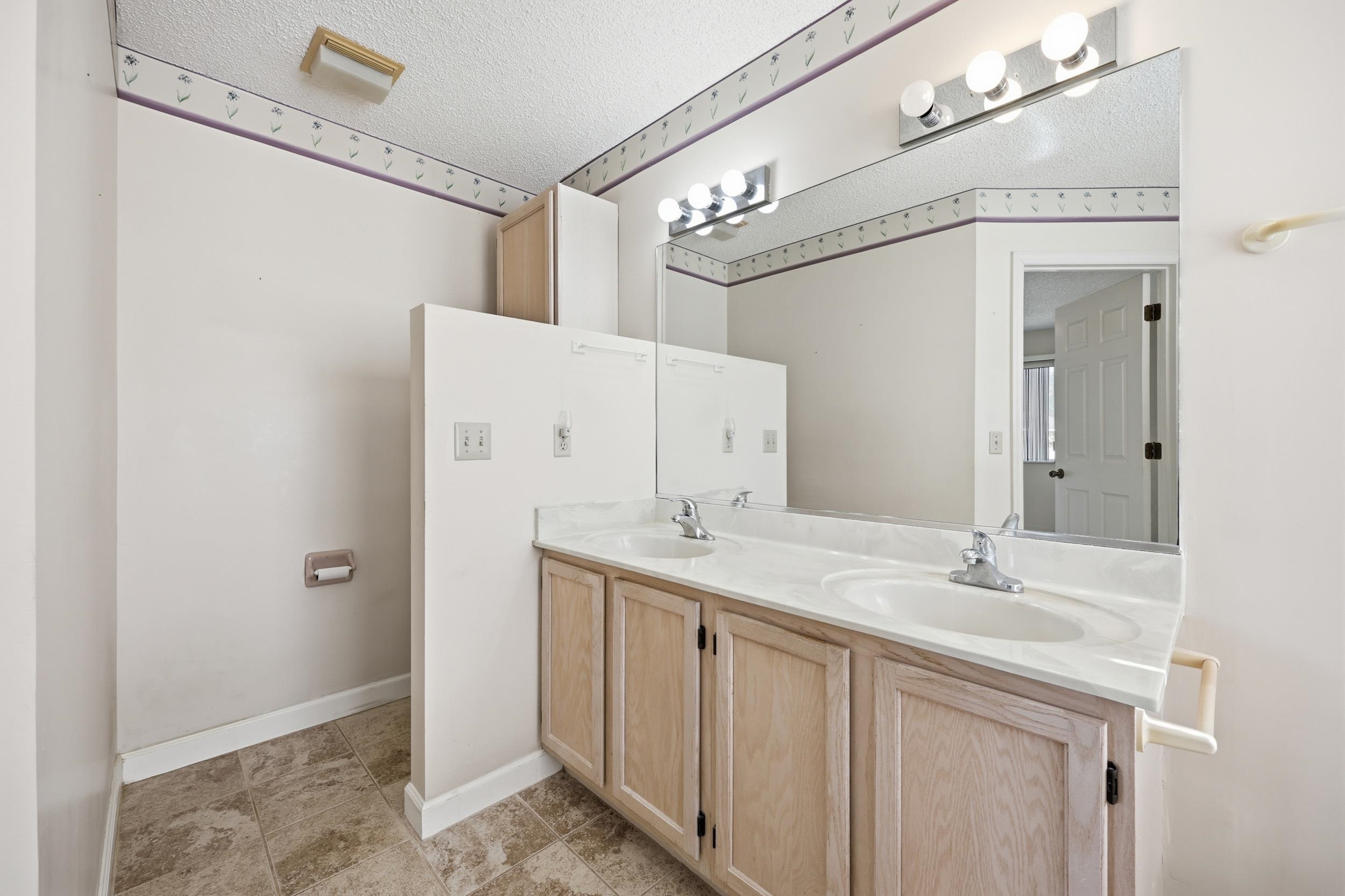 4628 Legends Lane Elkton, FL 32033 - Photo 21 of 49 a bathroom with a sink a mirror and a shower