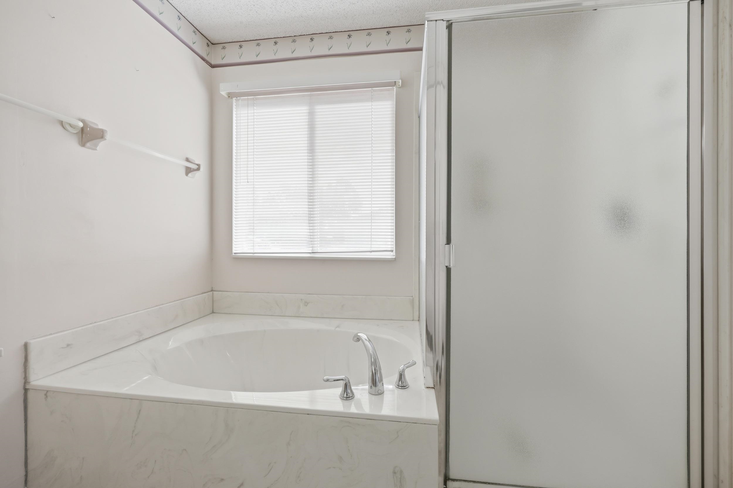 4628 Legends Lane Elkton, FL 32033 - Photo 22 of 49 Bathroom with a garden tub, a stall shower, and a textured ceiling