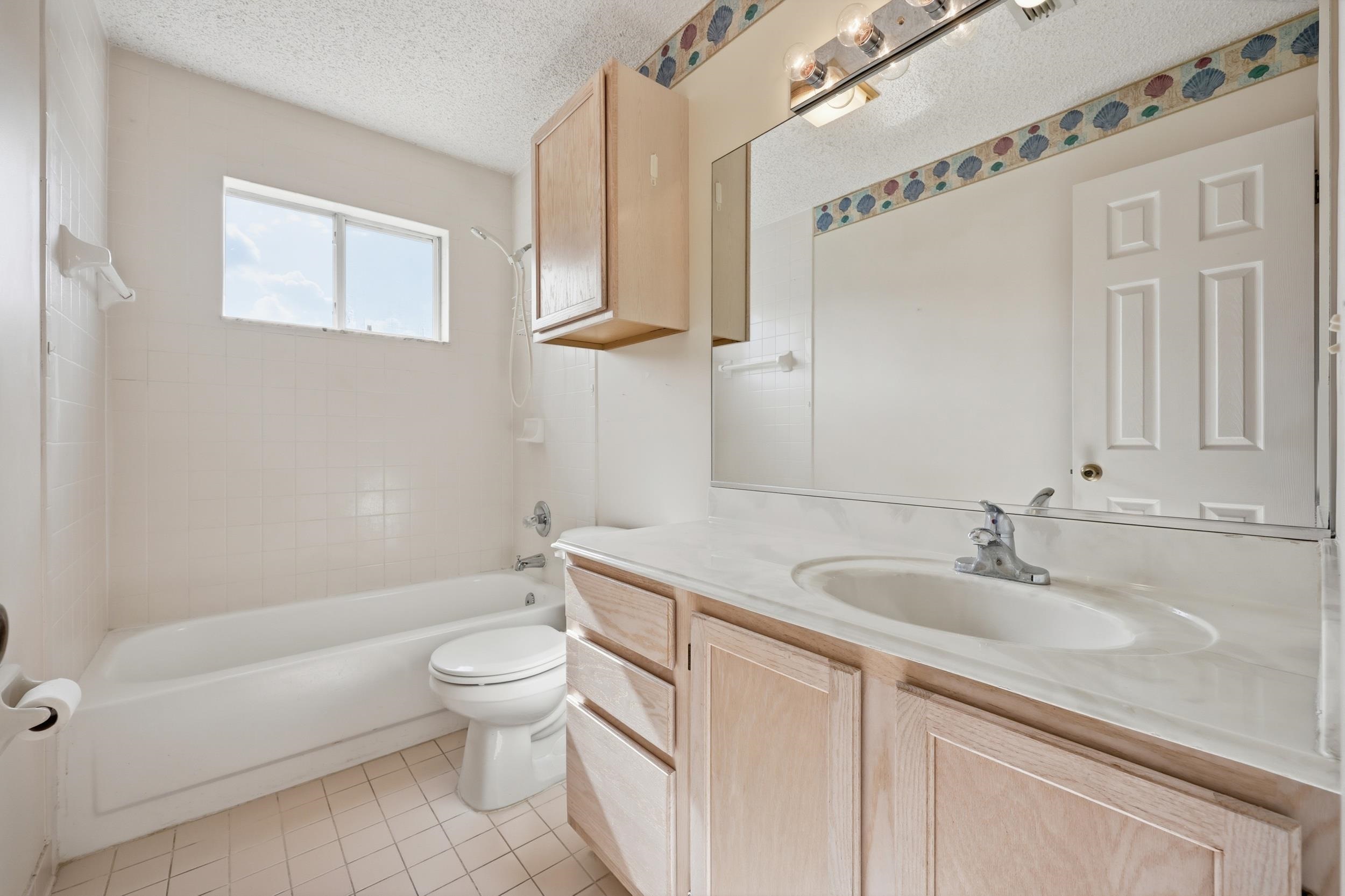 4628 Legends Lane Elkton, FL 32033 - Photo 23 of 49 Full bathroom featuring shower / bathtub combination, vanity, a textured ceiling, and light tile patterned floors