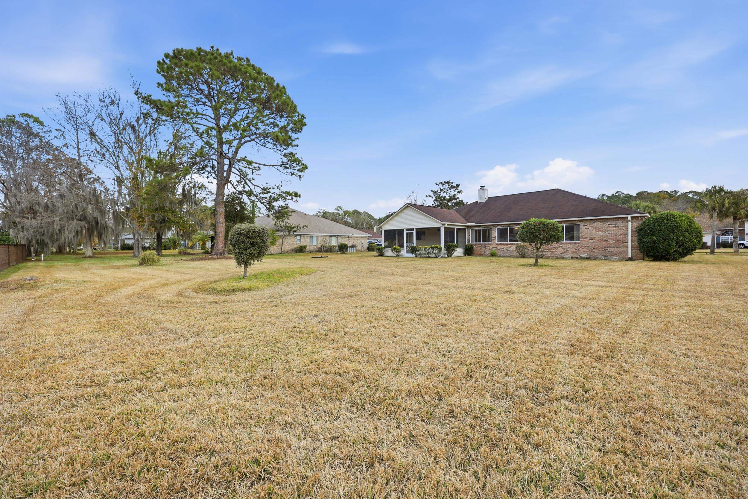4628 Legends Lane Elkton, FL 32033 - Photo 27 of 49 a view of a large garden with an buildings in the background