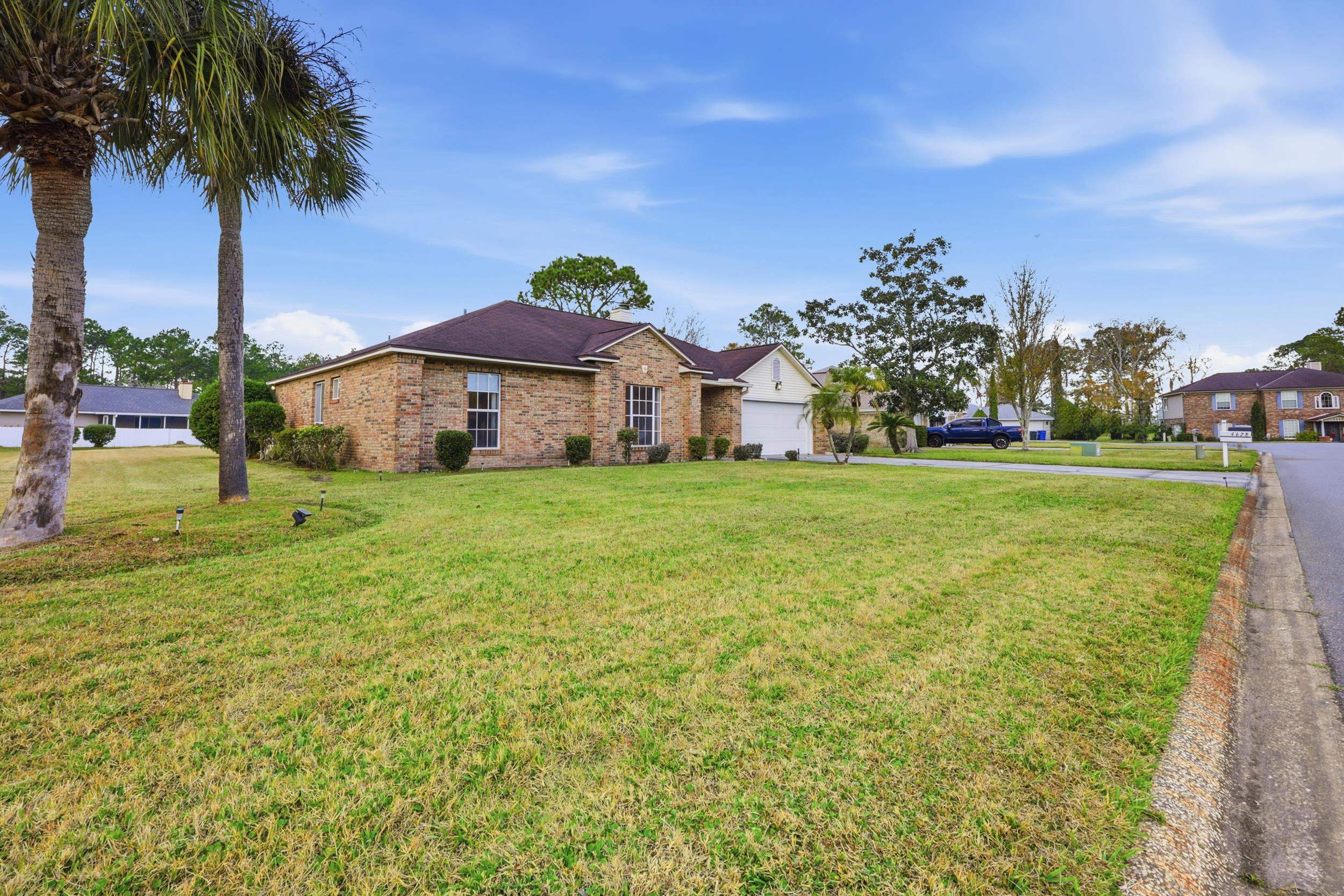 4628 Legends Lane Elkton, FL 32033 - Photo 33 of 49 a view of a house with a big yard and palm trees