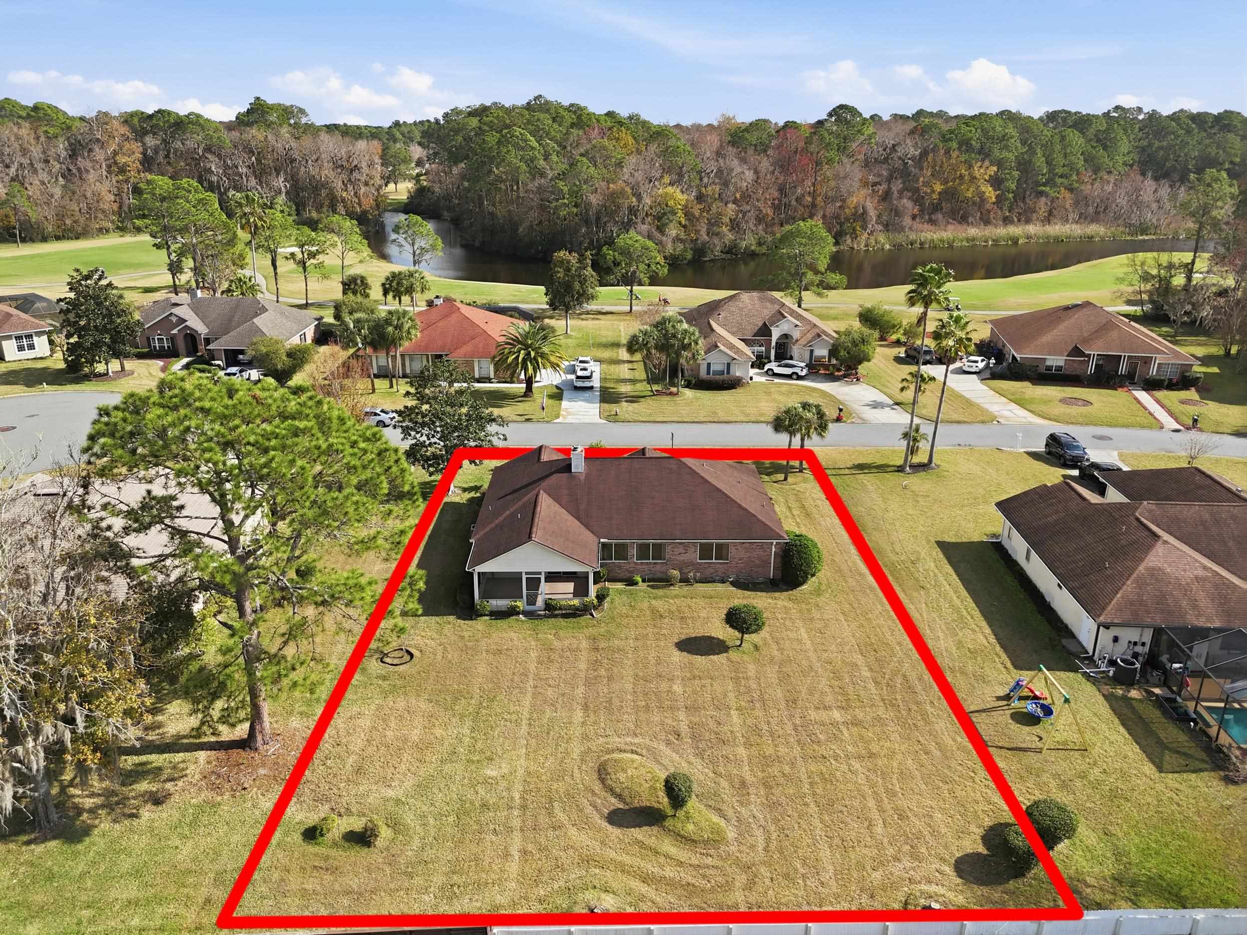 4628 Legends Lane Elkton, FL 32033 - Photo 36 of 49 Aerial view of residential area with property parcel outlined and a large body of water