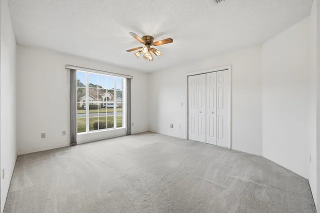 a view of a kitchen with a sink and a ceiling fan