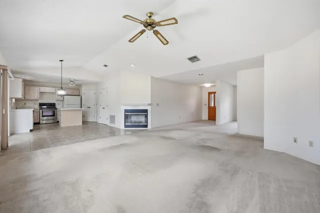 a kitchen with white cabinets and white appliances