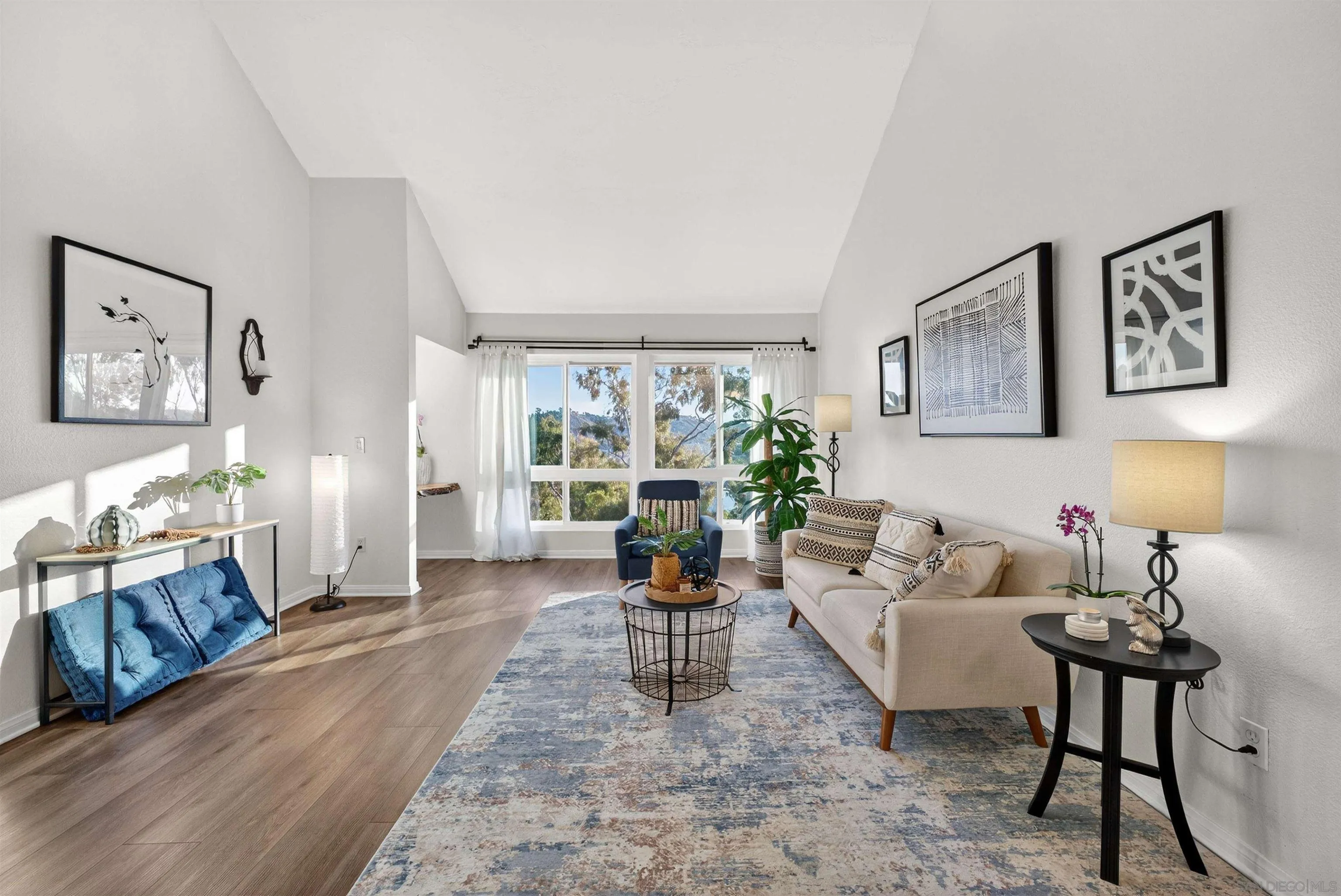 6255 Rancho Mission Road, Unit 302 San Diego, CA 92108 - Photo 2 of 28 a living room with furniture and a large window