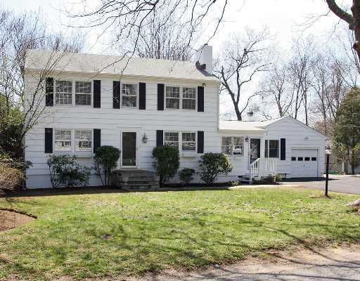 Undisclosed Address Darien, CT 06820 - Photo 1 of 7 a front view of a house with a yard