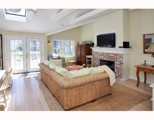 Undisclosed Address Darien, CT 06820 - Photo 6 of 7 a living room with furniture a flat screen tv and a fireplace