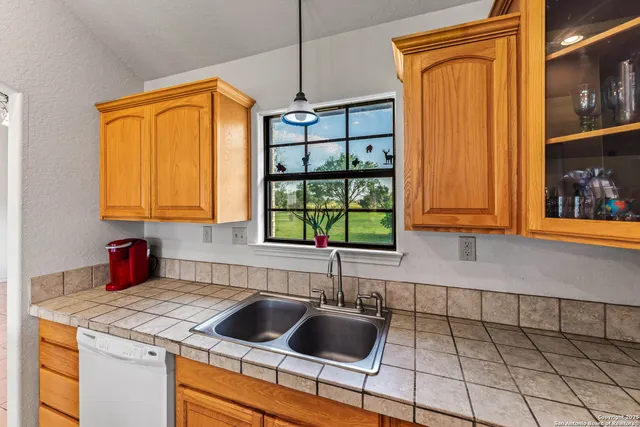 a kitchen with a sink cabinets and a large window