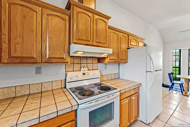 a kitchen with a stove and a refrigerator