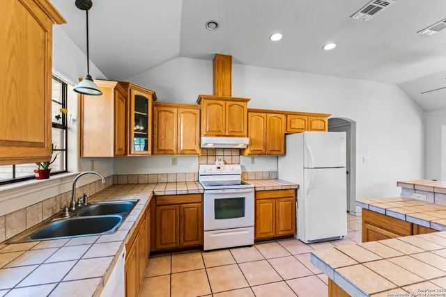 a kitchen with a sink appliances and cabinets