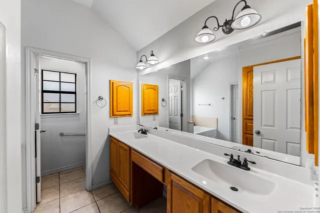 a bathroom with a double vanity sink mirror and double