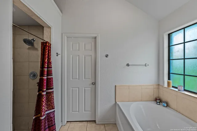 a bathroom with a bathtub and shower