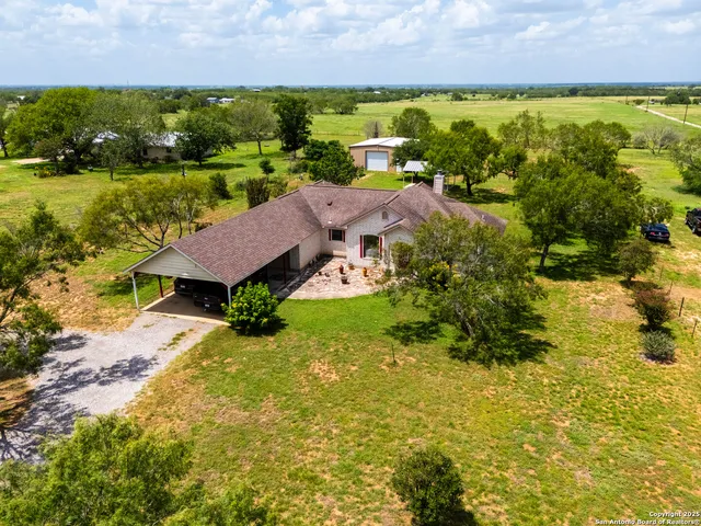 an aerial view of residential houses with outdoor space and swimming pool
