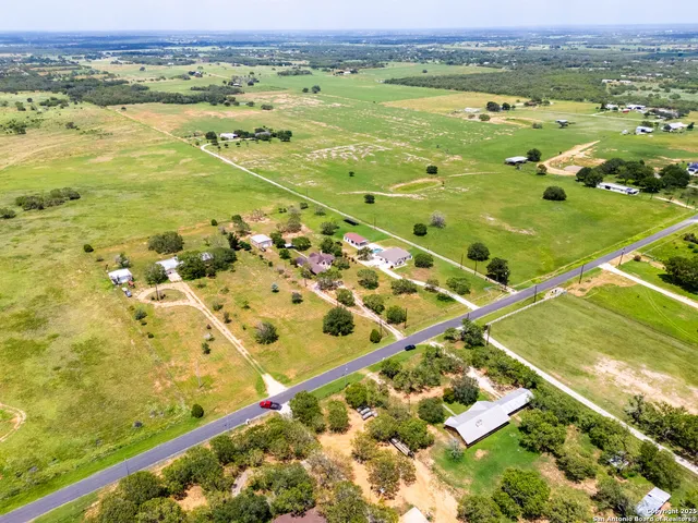 an aerial view of residential houses with outdoor space