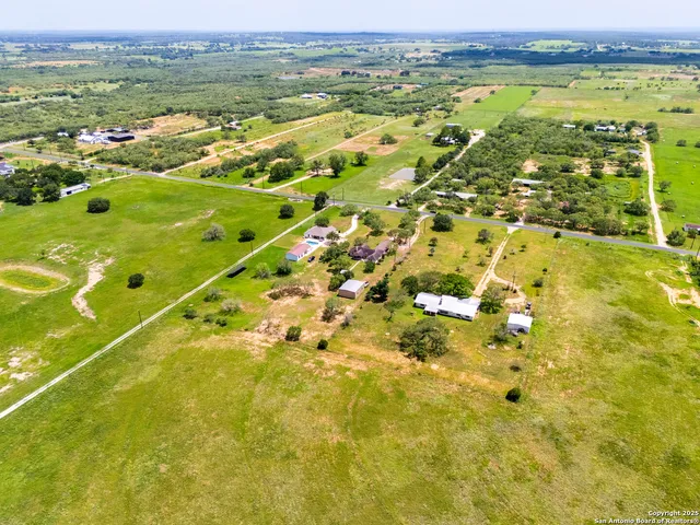 a view of a backyard with plants and a patio