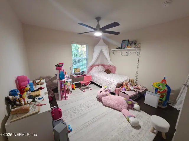 a bed room with a bed and a chandelier