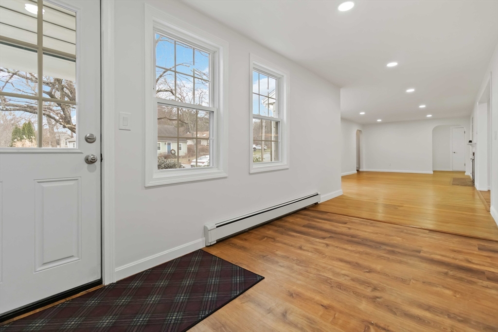 58 Cutler Drive Framingham, MA 01702 - Photo 16 of 36 a view of an empty room with window and wooden floor