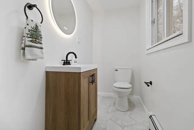 a bathroom with a toilet a sink and a mirror