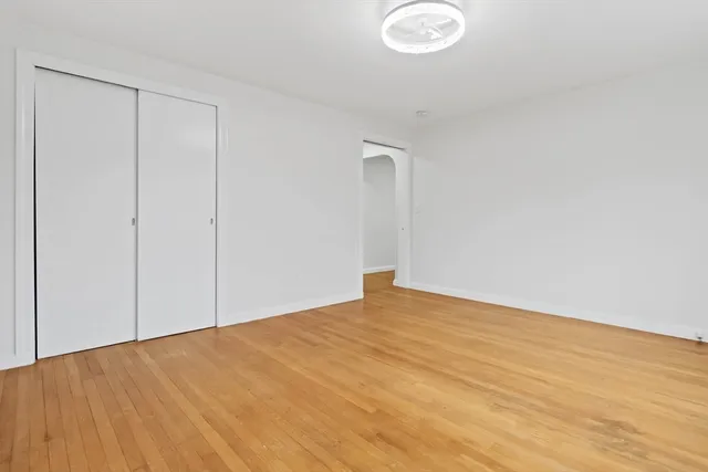 a view of an empty room and wooden floor