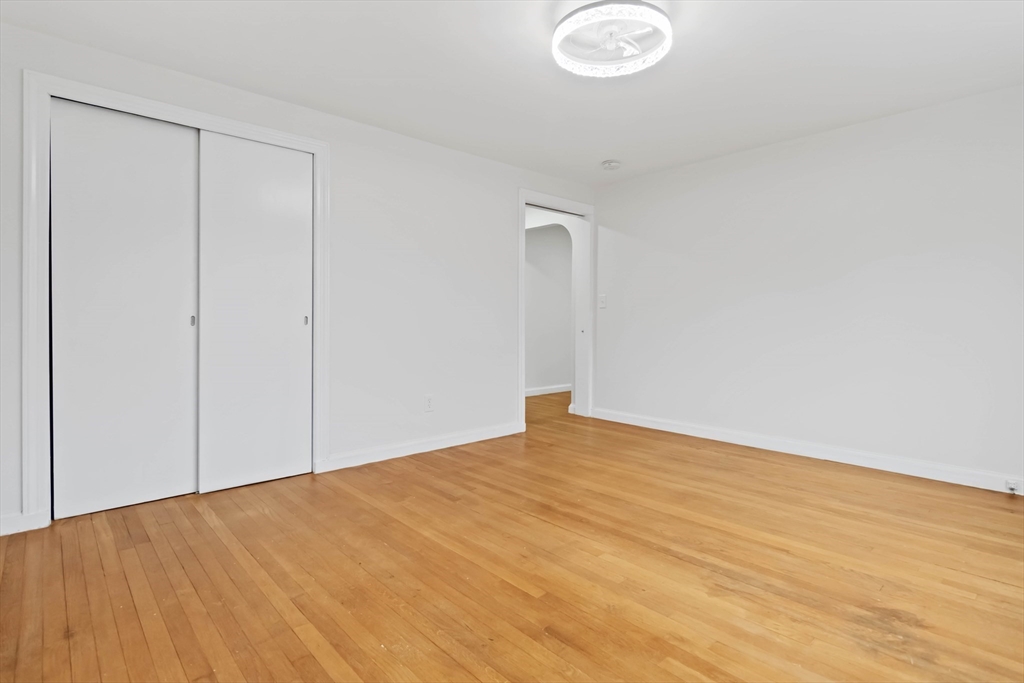 58 Cutler Drive Framingham, MA 01702 - Photo 25 of 36 a view of an empty room and wooden floor