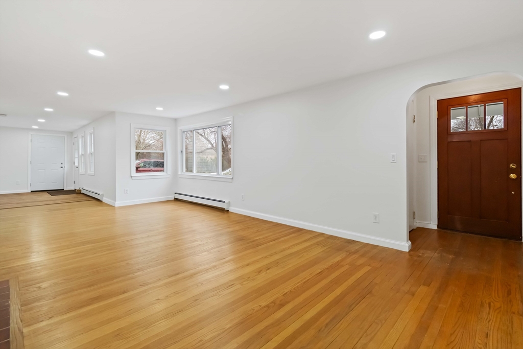 58 Cutler Drive Framingham, MA 01702 - Photo 6 of 36 a view of empty room with wooden floor and window