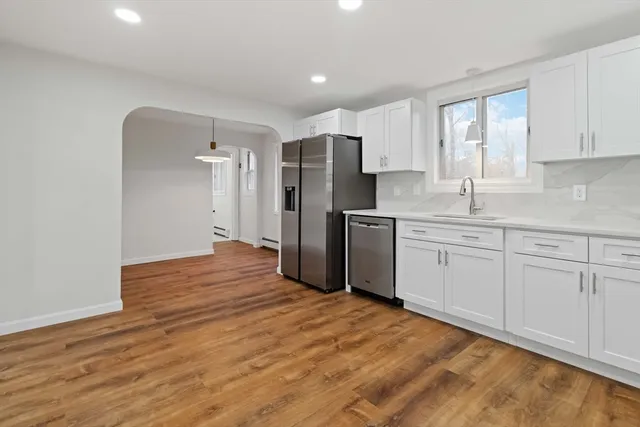 a kitchen with stainless steel appliances a refrigerator sink and cabinets