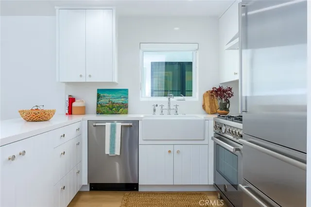 a kitchen with a sink cabinets and appliances