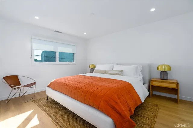 a bedroom with a bed and chair