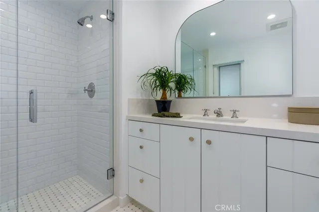 a bathroom with a shower sink and mirror