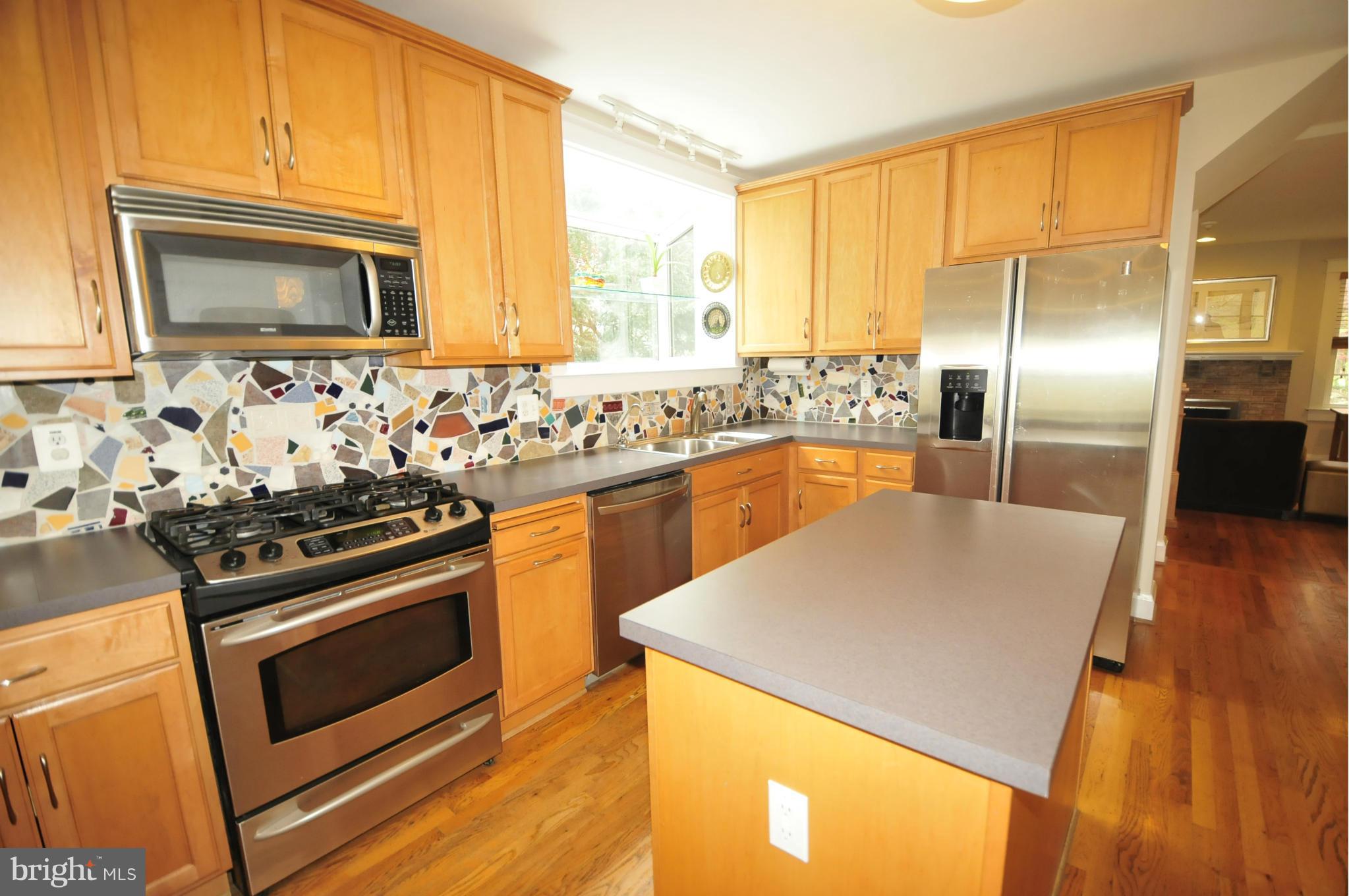 1825 Fairbank Road Baltimore, MD 21209 - Photo 10 of 27 a kitchen with stainless steel appliances granite countertop a stove a sink and a microwave