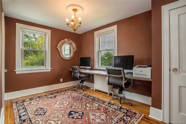 a view of a workspace with furniture and a window