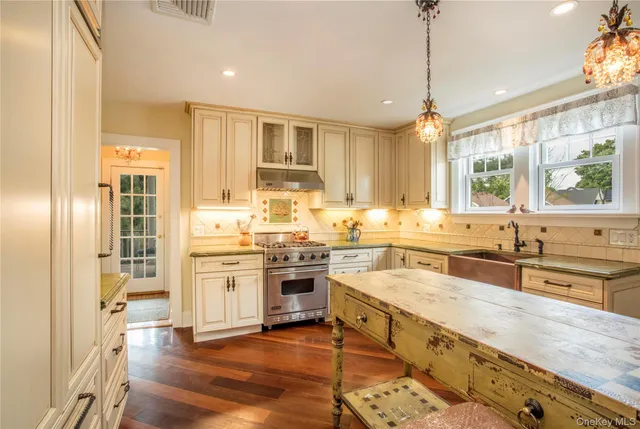 a large kitchen with stainless steel appliances granite countertop a lot of counter space and a sink