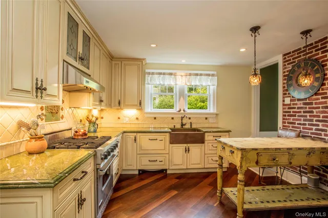 a kitchen with sink refrigerator and stove