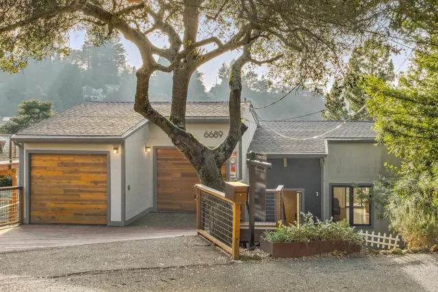 a view of a house with a tree
