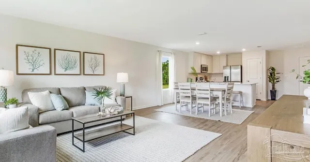 a living room with furniture and view of kitchen