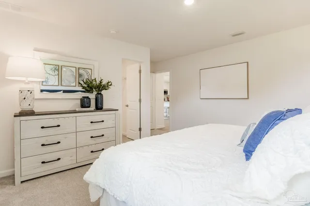 a bedroom with a bed and a dresser