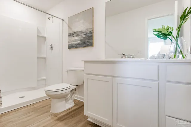 a bathroom with a toilet sink and shower