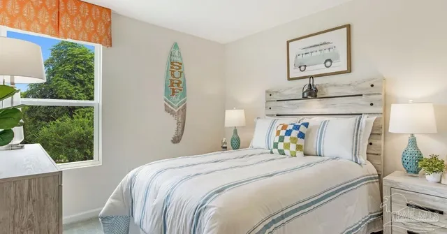 a bedroom with a bed and a window