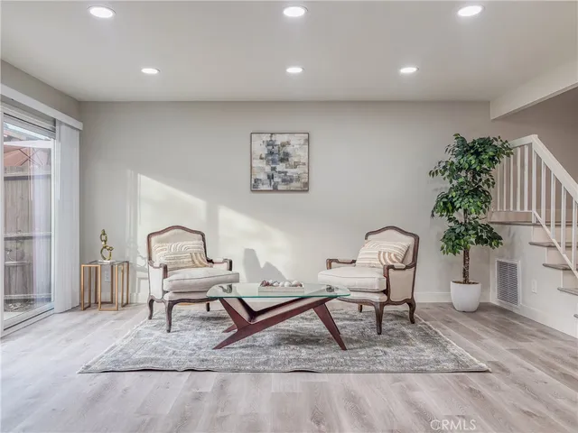 a living room with furniture and a potted plant